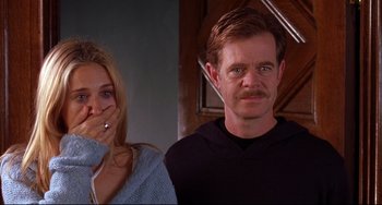 Movie still from “State and Main” (2000), directed by David Mamet – A man and a woman standing next to each other in front of a staircase; Close Up shot, Over the shoulder angle