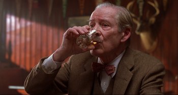 Movie still from “State and Main” (2000), directed by David Mamet – An older man in a suit and tie drinking a glass of beer; Close Up shot, Low angle