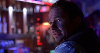 Movie still from “State and Main” (2000), directed by David Mamet – A person wearing a blue shirt; Close Up shot, Low angle