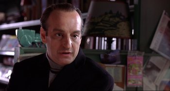 Movie still from “State and Main” (2000), directed by David Mamet – A person wearing a suit and tie; Close Up shot, Low angle