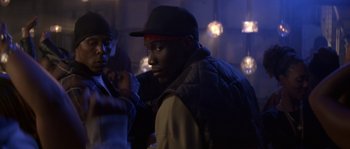 Movie still from “Step Up” (2006), directed by Anne Fletcher – A man with a black hat is standing next to another man; Close Up shot, Over the shoulder angle