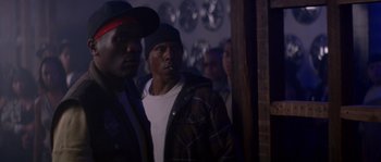 Movie still from “Step Up” (2006), directed by Anne Fletcher – A group of men standing next to each other in a room; Medium shot, Low angle