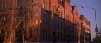 Movie still from “Step Up” (2006), directed by Anne Fletcher – A red brick building with traffic lights hanging from it's side; Extreme Wide shot, Low angle