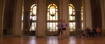Movie still from “Step Up” (2006), directed by Anne Fletcher – A man and a woman standing in front of stained glass windows; Wide shot, Low angle