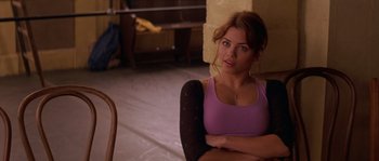 Movie still from “Step Up” (2006), directed by Anne Fletcher – A beautiful young lady sitting on a chair in a room; Close Up shot, Over the shoulder angle