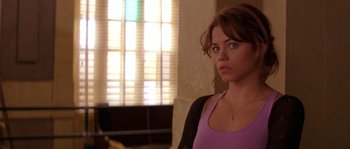 Movie still from “Step Up” (2006), directed by Anne Fletcher – A woman standing in front of a window looking to her left; Close Up shot, Over the shoulder angle