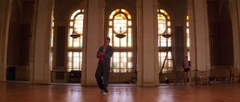 Movie still from “Step Up” (2006), directed by Anne Fletcher – A man standing in front of stained glass in a room; Wide shot, Low angle
