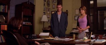 Movie still from “Step Up” (2006), directed by Anne Fletcher – A man standing in front of a table with papers on it; Medium shot, Over the shoulder angle