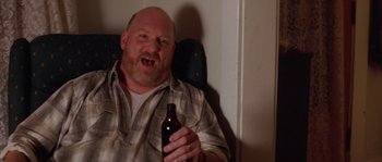 Movie still from “Step Up” (2006), directed by Anne Fletcher – A man holding a bottle of beer in his hand; Close Up shot, High angle