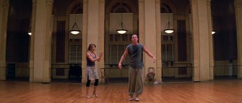 Movie still from “Step Up” (2006), directed by Anne Fletcher – A man and a woman are dancing in a room; Wide shot, Low angle