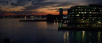 Movie still from “Step Up” (2006), directed by Anne Fletcher – A view of a city at night from across a river; Extreme Wide shot, High angle