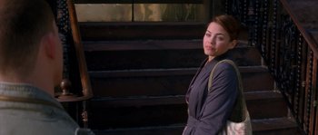 Movie still from “Step Up” (2006), directed by Anne Fletcher – A woman standing in front of some stairs; Medium shot, Over the shoulder angle