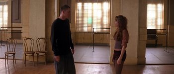 Movie still from “Step Up” (2006), directed by Anne Fletcher – A man and a woman standing in front of each other in a room; Medium shot, Low angle