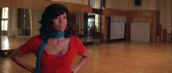 Movie still from “Step Up” (2006), directed by Anne Fletcher – A woman in a red dress standing in an empty room; Close Up shot, Low angle