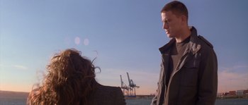 Movie still from “Step Up” (2006), directed by Anne Fletcher – A man and a woman standing next to each other in front of a body of water; Medium shot, Over the shoulder angle