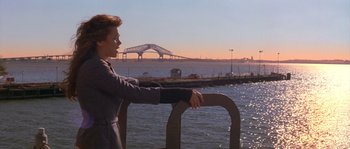 Movie still from “Step Up” (2006), directed by Anne Fletcher – A woman looking out over the water from a pier; Medium shot, Low angle