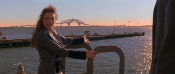 Movie still from “Step Up” (2006), directed by Anne Fletcher – A woman standing on a pier near the water; Medium shot, Low angle