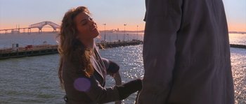 Movie still from “Step Up” (2006), directed by Anne Fletcher – A woman standing next to a man on a pier; Medium shot, Over the shoulder angle
