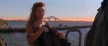 Movie still from “Step Up” (2006), directed by Anne Fletcher – A beautiful woman holding onto a blanket near the water; Medium shot, Over the shoulder angle