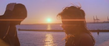 Movie still from “Step Up” (2006), directed by Anne Fletcher – A woman looking out over the ocean at sunset; Close Up shot, Low angle