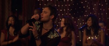 Movie still from “Step Up” (2006), directed by Anne Fletcher – A man and a woman singing in front of a crowd of onlookers; Close Up shot, Low angle