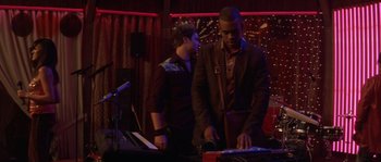 Movie still from “Step Up” (2006), directed by Anne Fletcher – Two men standing next to each other in front of a keyboard; Medium shot, Over the shoulder angle