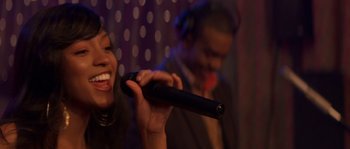 Movie still from “Step Up” (2006), directed by Anne Fletcher – A woman holding a microphone in front of a man in headphones; Close Up shot, Over the shoulder angle