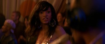 Movie still from “Step Up” (2006), directed by Anne Fletcher – A woman in a gold dress with big earrings; Close Up shot, Over the shoulder angle