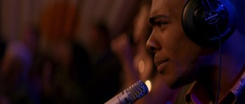 Movie still from “Step Up” (2006), directed by Anne Fletcher – A person holding a microphone; Close Up shot, Over the shoulder angle