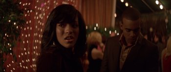 Movie still from “Step Up” (2006), directed by Anne Fletcher – A young woman with long black hair standing next to a man in a black suit; Close Up shot, Over the shoulder angle