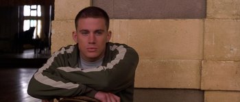 Movie still from “Step Up” (2006), directed by Anne Fletcher – A young man sitting in front of a brick wall; Close Up shot, Low angle