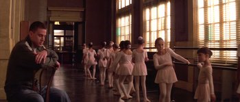 Movie still from “Step Up” (2006), directed by Anne Fletcher – A group of young ballerinas are lined up in front of a window; Medium shot, Over the shoulder angle