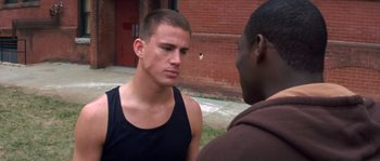Movie still from “Step Up” (2006), directed by Anne Fletcher – Two men are standing outside talking to each other; Close Up shot, Over the shoulder angle