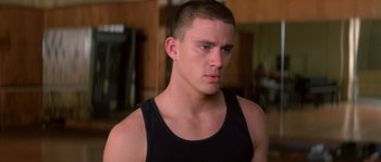 Movie still from “Step Up” (2006), directed by Anne Fletcher – A person wearing a tank top; Close Up shot, Over the shoulder angle