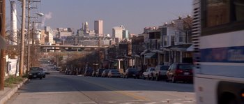Movie still from “Step Up” (2006), directed by Anne Fletcher – Cars parked on the side of the road in a city; Extreme Wide shot, High angle