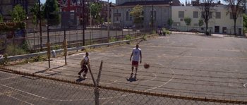 Movie still from “Step Up” (2006), directed by Anne Fletcher – Two young men playing basketball on a basketball court; Extreme Wide shot, High angle