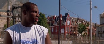 Movie still from “Step Up” (2006), directed by Anne Fletcher – A man standing in front of a red brick building; Close Up shot, Low angle
