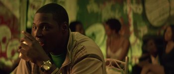 Movie still from “Step Up” (2006), directed by Anne Fletcher – A man sitting in front of other people in a room; Close Up shot, Over the shoulder angle