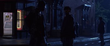 Movie still from “Step Up” (2006), directed by Anne Fletcher – Two men standing on the side of the street at night; Medium shot, Over the shoulder angle