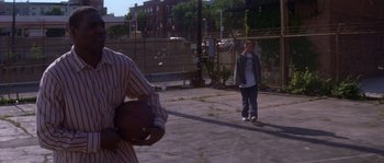 Movie still from “Step Up” (2006), directed by Anne Fletcher – Two young men are playing basketball on a court; Medium shot, Over the shoulder angle