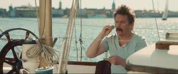 Movie still from “Stockholm” (2018), directed by Robert Budreau – A man on a sailboat brushing his teeth; Medium shot, Over the shoulder angle