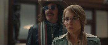 Movie still from “Stockholm” (2018), directed by Robert Budreau – A man and a woman wearing glasses and hats; Close Up shot, Over the shoulder angle