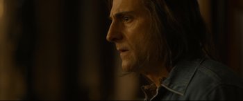 Movie still from “Stockholm” (2018), directed by Robert Budreau – A person with long brown hair; Close Up shot, Over the shoulder angle