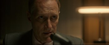 Movie still from “Stockholm” (2018), directed by Robert Budreau – A person holding a microphone; Close Up shot, Over the shoulder angle