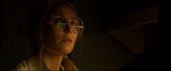 Movie still from “Stockholm” (2018), directed by Robert Budreau – A person wearing glasses; Close Up shot, Low angle
