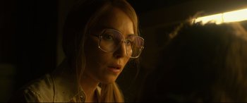 Movie still from “Stockholm” (2018), directed by Robert Budreau – A person wearing glasses; Close Up shot, Low angle
