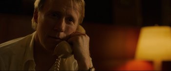 Movie still from “Stockholm” (2018), directed by Robert Budreau – A man holding a phone up to his ear; Close Up shot, Over the shoulder angle