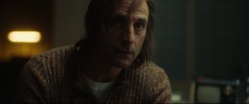 Movie still from “Stockholm” (2018), directed by Robert Budreau – A person with long hair; Close Up shot, Low angle