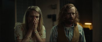 Movie still from “Stockholm” (2018), directed by Robert Budreau – A woman and a man standing next to each other in a room; Close Up shot, Low angle