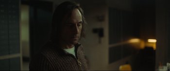 Movie still from “Stockholm” (2018), directed by Robert Budreau – A person with long hair; Close Up shot, Over the shoulder angle